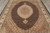 Top-down photo of black herati fish pattern field surrounding an ivory and brown lobed medallion