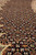 Macro of herati fish motif diamonds in rust, olive and ivory on black wool pile