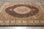Angled floor view showing 8x10 wool and silk Mahi rug with camel spandrels and ivory border