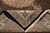 Folded-back corner revealing fine weave, black selvage, cotton fringe and the reverse of the Mahi pattern