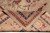 Folded corner revealing the woven back, even low pile and tight hand-knotted structure of this rug