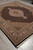 Ivory medallion and camel spandrels seen from the corner of this black ground rug