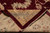 Folded corner revealing dense hand-knotted back, cotton foundation and cream fringe of the wool rug
