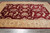 8'8" x 13'4" Zigler Chobi rug photographed from above on grey tile, showing burgundy field