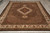 Angled floor view of the 8x10 hand-knotted area rug with ivory palmette border and cream fringe