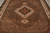 Overhead detail of the central medallion, herati diamond lattice and rust pendant on brown ground