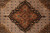 Macro detail of navy medallion core with rust petals, olive leaves and ivory herati infill