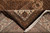 Folded corner exposing the finely knotted reverse, brown selvedge and hand-tied ivory cotton fringe