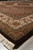 Low angle of the 8'1" x 10' area rug corner with ivory fringe on tile floor
