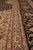 Macro detail of ivory guard border, paisley boteh motifs and fine wool and silk pile