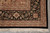Corner detail with black main border, palmettes and ivory boteh guard stripe above fringe