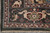 Ivory fringe and finished selvage along the green end border of this wool rug