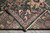 Folded corner revealing tight back weave, knot detail and cotton foundation of the wool rug