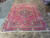 8'9" x 11'11" hand-knotted Persian rug laid flat on a showroom floor, full pattern visible