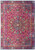 Deep red Persian Sheikh Safi rug with navy medallion, ivory palmettes and floral border, overhead view