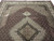 Diagonal floor view highlighting silk sheen across the fish pattern lattice and dark medallion center