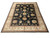Large 10 x 14 black rug displayed flat, ivory palmette border framing all-over floral vinework