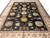 9'9" x 13'9" black Oriental rug with ivory guard borders and burgundy vine stripe detail