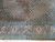 Close-up of mauve salmon border with ivory palmettes, floral vines and multiple guard stripes