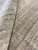 Folded corner detail showing dense hand-knotted wool pile and soft gray striation across the surface