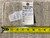 Back tag reading Genuine Hand Woven Oriental Rug number 6592 beside a Stanley tape measure