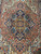 Brick field surrounding the 8 sided medallion flanked by sky blue and ivory palmettes
