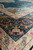 Angled macro of main border showing blush, gold and teal palmette detail in silk