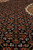 Low-angle close-up of rust, ivory and slate blue flowers repeating across the black field