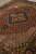 Angled floor view highlighting silk outlined fish motifs surrounding the gold and black central medallion
