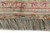 Woven signature cartouche in the end border above long silvery silk fringe, close-up