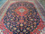 Dense allover floral drawing in madder red, turquoise, gold and ivory across midnight navy