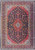 Navy blue Persian Kashan rug with red medallion, ivory corner spandrels and dense floral field