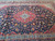 9'8" x 13'3" Kashan rug close up on navy field with palmettes and light storage folds