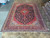 10x13 Persian Kashan rug laid flat, showing balanced medallion layout and clean selvedge edges