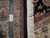 Ruler against fine wool and silk pile showing dense hand-knotted weave, ivory fringe and black selvage