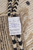 Original back label reading hand-knotted in Pakistan, 100% natural wool, Moroccan modern contemporary pattern