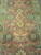 Close-up of all over floral field, gold diamond lozenge motifs and 8 petal rosettes