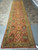 Complete 4'2 x 18'6 Indian runner rug photographed end to end on tile and concrete flooring
