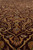 Ground level view of burgundy Esfahan design field with gold vinescroll and ivory blossoms