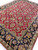 Perspective view of 9 x 12 Jaipur wool rug, burgundy field meeting deep black floral main border