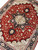 Rust field and ivory 8 pointed medallion viewed diagonally with salmon, green and gold accents