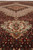 Low angle along the red field toward the ivory medallion and cream pendant cartouche