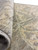 Folded back corner revealing dense hand-knotted wool pile, tight weave and soft ivory border detail
