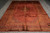8'7 x 12'4 hand-knotted Persian rug photographed flat on grey floor with central medallion