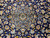 Central floral medallion of this vintage 1980s Persian rug, ivory and gold vines on navy