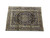 9x13 navy Kashan area rug laid flat on white studio floor, full design visible