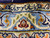 Close-up of the woven signature cartouche set into the light blue border of this rug