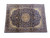 Hand-knotted wool Isfahan rug shot at an angle showing navy field, cream corners and multi-band border