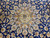 Sky blue and gold medallion radiating palmettes across the deep navy floral wool field