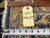 Reverse of the rug with inventory tag, tape measure and visible cotton foundation knot rows